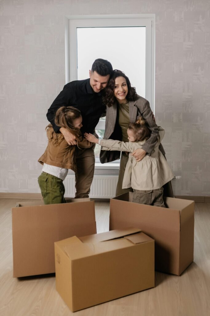 Happy family embracing their new home following house move.